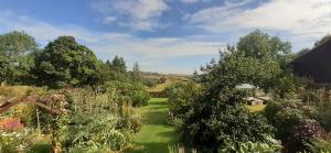 a garden with trees and plants on a field at Meadowsweet @ Laneside in Whitby