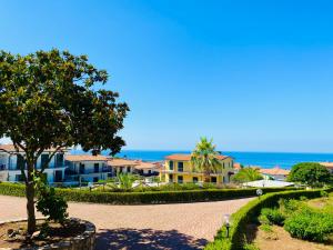 a cobblestone road in front of houses with a tree at Marina Apartament in Scalea