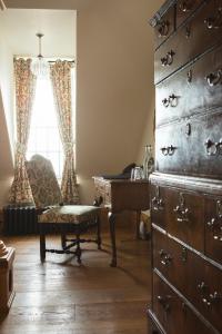 a room with a dresser and a desk and a chair at Mingary Castle - Restaurant with Rooms in Kilchoan
