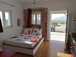 a bedroom with a bed and a door to a patio at Countryside Retreat 1 in Agios Arsenios +18 photos