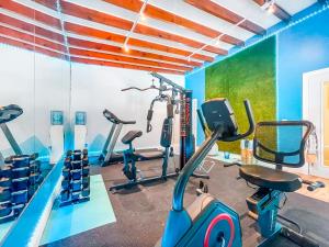 un gimnasio con cintas de correr y bicicletas estáticas en una habitación en Greniers, en Hollywood