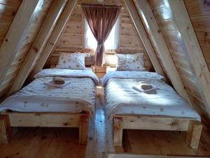 two beds in a room with a window at Holiday_home _Jana in Žabljak