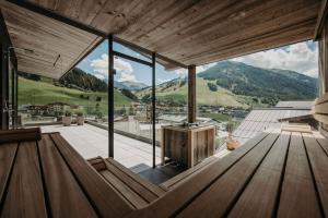 a large room with a view of the mountains at Hotel VIEW - incl Joker Card in Summer in Saalbach Hinterglemm