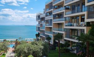 an apartment building with a view of the ocean at Dolce Vita II Waterfront Breeze Sea View Luxury Apartament in Sveti Vlas