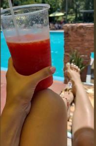 a woman is holding a drink in her hand at Complejo Don Raúl in Puerto Rico +31 photos