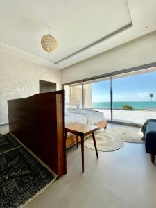 a bedroom with a bed and a view of the ocean at Paradisiac and luxurious villa with private beach in Dakhla in Dakhla