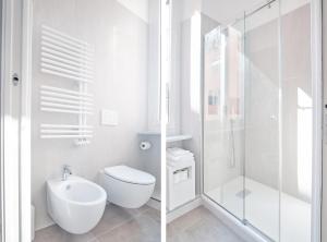 a white bathroom with a toilet and a shower at Casa Contra in La Spezia +40 photos