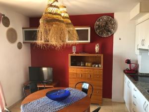 a kitchen with a table with a blue bowl on it at Apartamentos Playa Torrenostra in Torrenostra