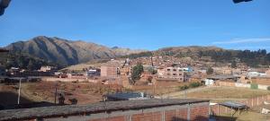 a view of a city with mountains in the background at CASA HOSPEDAJE Nancy-CHINCHERO in Cusco