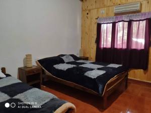 a bedroom with two beds and a window at Complejo Don Raúl in Puerto Rico