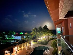 a view of the pool at night at PORTO CAYMAN RESIDENCE - BEIRA MAR - próximo a Igreja de São Pedro de Padre Arlindo - in Tamandaré