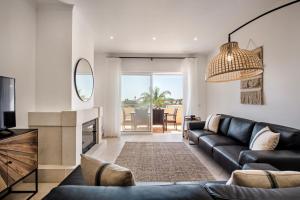 - un salon avec un canapé, une télévision et un miroir dans l'établissement Beautiful Two Bedroom Apartment with Roof Terrace, à Carvoeiro