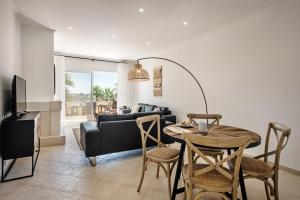 a living room with a table and a couch at Modern and Spacious Two Bedroom Apartment in Carvoeiro