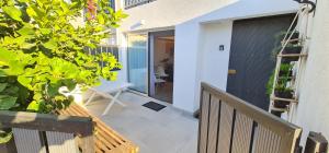a balcony of a house with a bench and a door at Sherpa Apartments in Ayia Napa