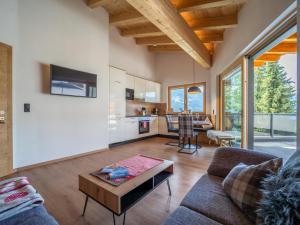 a living room with a couch and a table at Chalet Georg in Zellberg