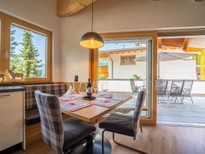 a kitchen and dining room with a table and chairs at Chalet Georg in Zellberg