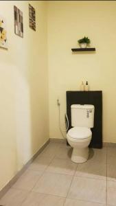 a bathroom with a white toilet in a room at Light Blue Villa in Tepus