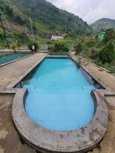 a large pool of blue water in the middle of a road at Organic Farm Homestay in Sa Pa