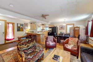 a living room filled with furniture and a kitchen at Cottonwood Cottage in Moab