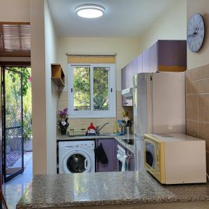a kitchen with a refrigerator and a washing machine at Paphos town house vacation in Paphos City