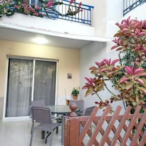 a patio with a table and chairs and a balcony at Paphos town house vacation in Paphos City +18 photos