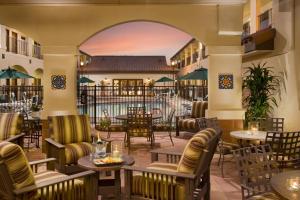 a lobby of a resort with tables and chairs at Ayres Hotel Redlands - Loma Linda in Redlands