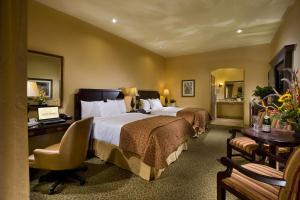 a hotel room with two beds and a desk at Ayres Hotel Redlands - Loma Linda in Redlands