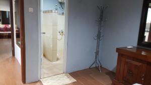 a bathroom with a shower and a glass door at Maninjau House in Jakarta +9 photos