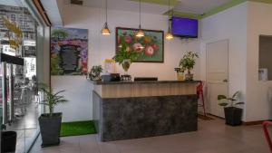 a bar in a restaurant with potted plants at Highlanders Hotel in Cameron Highlands
