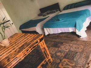 a bedroom with a bed and a wooden bench at Niwasa House in Hatton