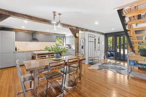 a kitchen and dining room with a table and chairs at Woodlands Retreat in Ocean Grove