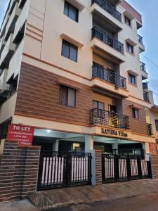 a building with a fence in front of it at RV backpackers in Bangalore