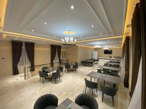 un restaurante con mesas y sillas en una habitación en Turon Lux Hotel, en Samarkand