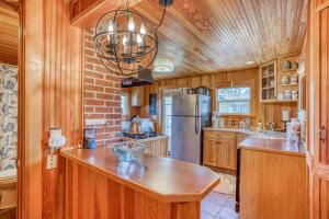 a kitchen with wooden cabinets and aendant light at The Captains Place in Lincoln City +76 photos