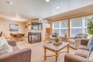 a living room filled with furniture and a fireplace at Pelicans Nest - Meredith Lodging in Pacific City