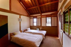 Ένα ή περισσότερα κρεβάτια σε δωμάτιο στο Guest House Eleven Village Fukiya +106 φωτογραφίες