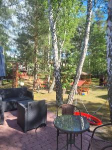 a patio with a table and chairs and a playground at FALA na WYSPIE in Gdańsk