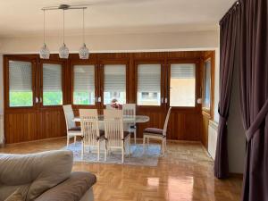 a dining room with a table and chairs at Holiday Home Hodo in Sarajevo
