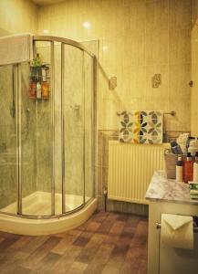 a bathroom with a shower and a sink at Alma Cliffe Guest House in Barnoldswick