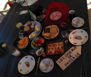 a table with a bunch of food on it at Les Oiseaux de Passage in Gignac