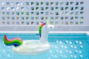 a pool with a unicorn toy in a swimming pool at Good View Pool Villa Udonthani in Udon Thani