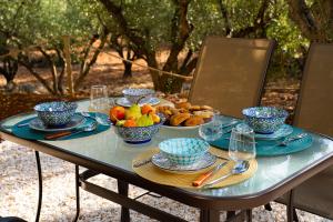 a table with bowls of fruit and plates of food at Thalassa Green in Agios Nikolaos