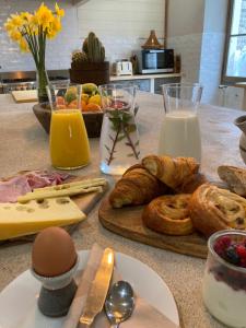 a table with bread and pastries and eggs and milk at No12 in Mansle