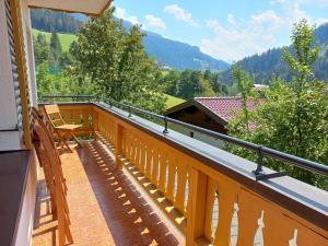 a balcony with a chair and a view of a mountain at Frühstückspension Wagrain - Viktoria Flasch in Wagrain