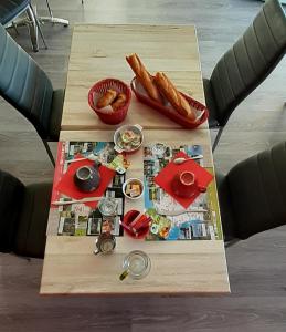 a table with food and bread on top of it at Résidence Hôtelière Hélios in Jonzac