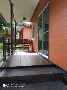 an empty porch of a house with glass doors at Lok Mun Bungalows in Ko Yao Noi