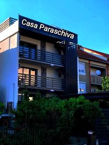 a building with a sign for a casa parais inclusive at CASA PARASCHIVA in Orşova