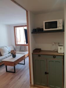 a living room with a table and a microwave at Mandilar Confort Panticosa in Panticosa +19 photos