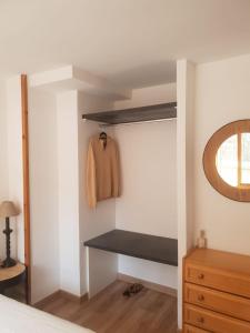 a bedroom with a closet with a bed and a mirror at Mandilar Confort Panticosa in Panticosa