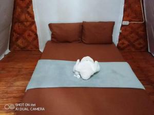 a bed with a white toy animal on it at SHUKRAN Apartelle in Siquijor +214 photos